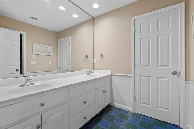 bathroom featuring tile patterned flooring and vanity