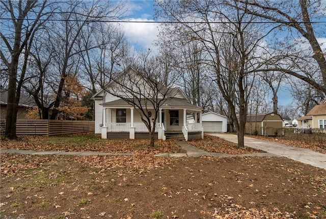 view of front facade with covered porch, an outdoor structure, and a garage