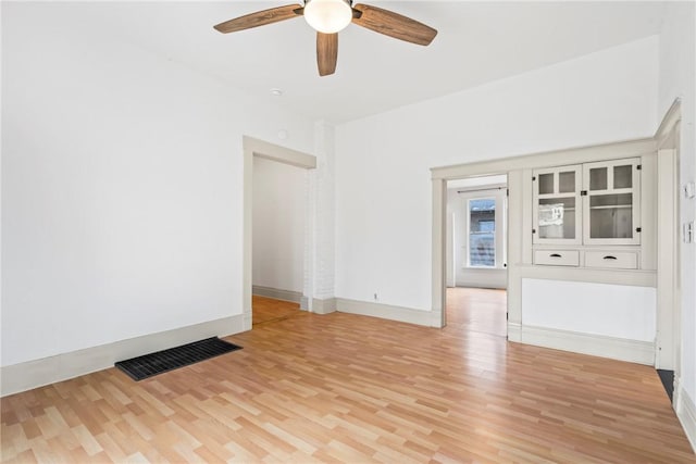 spare room with ceiling fan and light wood-type flooring