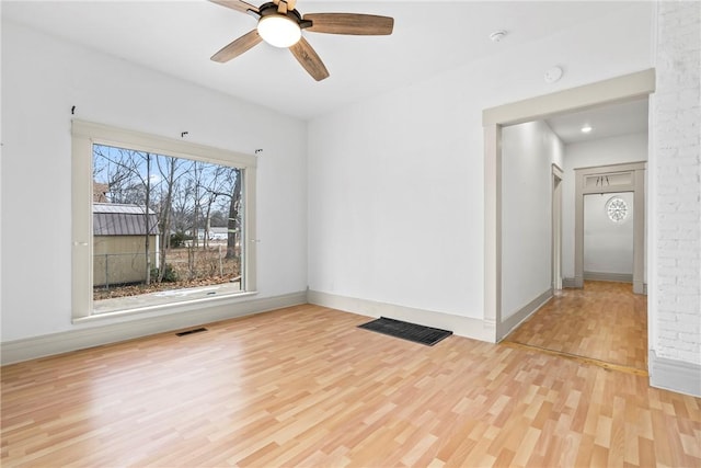 unfurnished room featuring light hardwood / wood-style flooring and ceiling fan