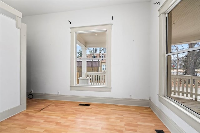 empty room with light hardwood / wood-style floors