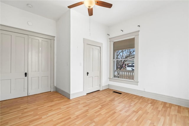 unfurnished bedroom with ceiling fan and light hardwood / wood-style floors