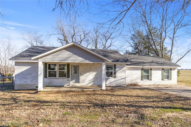 single story home with a porch and a front lawn