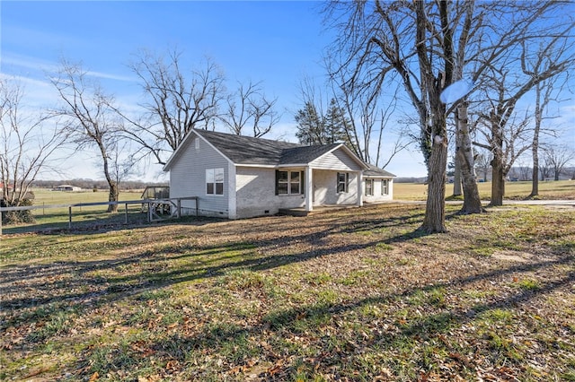 view of front of property with a front yard and a rural view