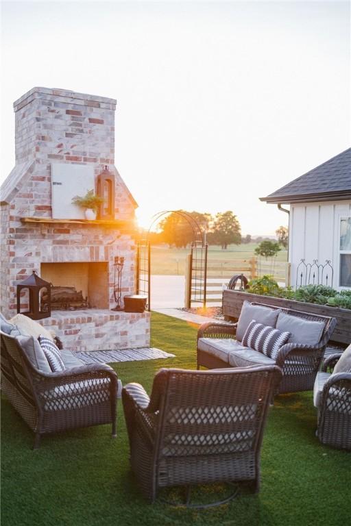 view of yard featuring an outdoor living space with a fireplace