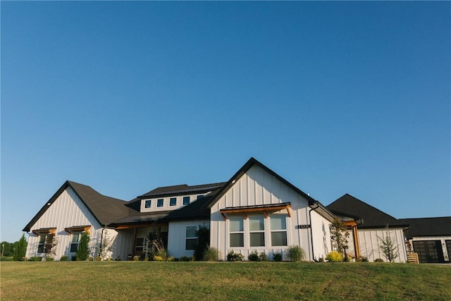 modern inspired farmhouse with a front lawn