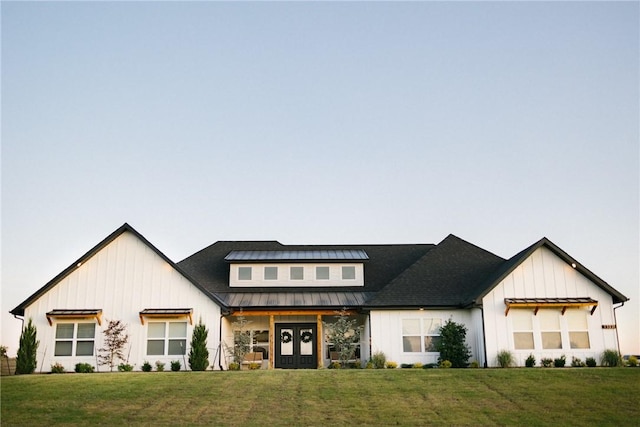 modern farmhouse featuring french doors and a front yard