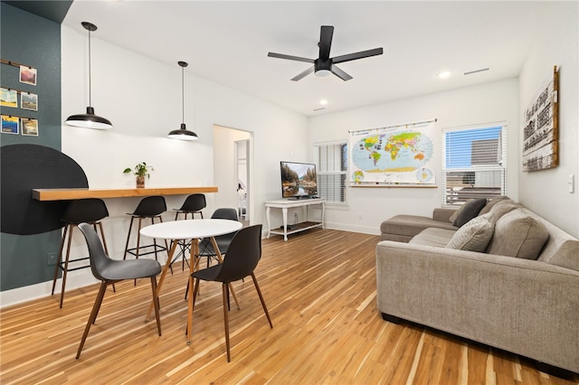 living room featuring ceiling fan and hardwood / wood-style floors