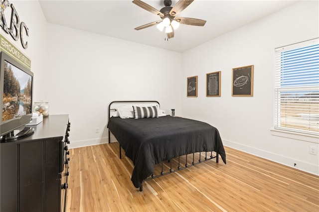 bedroom with ceiling fan and wood-type flooring