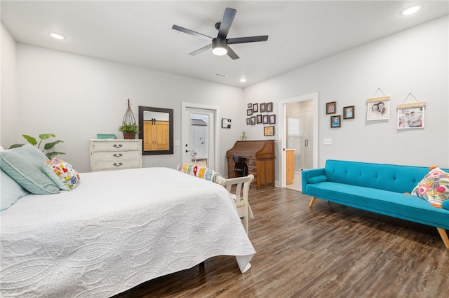 bedroom with ceiling fan, dark wood-type flooring, and connected bathroom