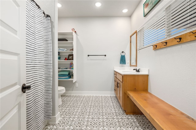 bathroom featuring toilet, tile patterned floors, and vanity