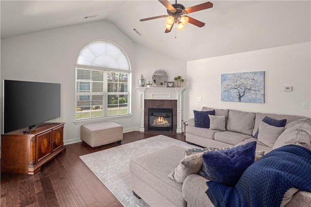 living room with dark hardwood / wood-style floors, ceiling fan, and lofted ceiling