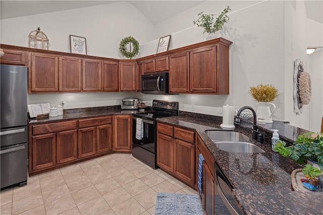 kitchen featuring dark stone counters, sink, black appliances, light tile patterned floors, and high vaulted ceiling