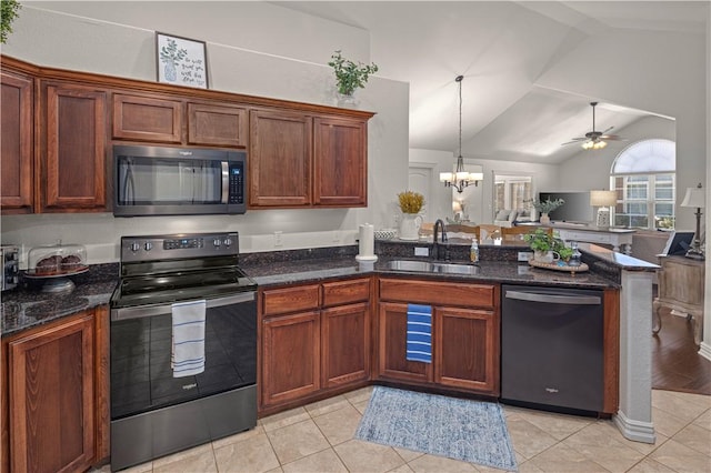 kitchen with ceiling fan with notable chandelier, stainless steel appliances, vaulted ceiling, sink, and light tile patterned floors