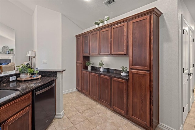 kitchen with dishwasher, dark stone countertops, and light tile patterned floors