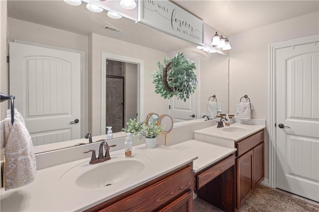 bathroom featuring a notable chandelier, vanity, and a shower with door