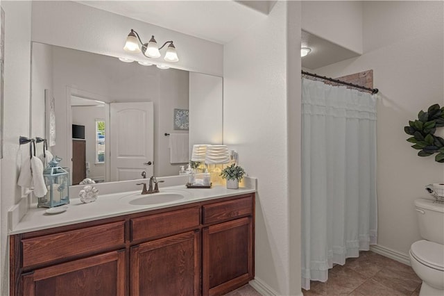 bathroom featuring tile patterned flooring, vanity, curtained shower, and toilet