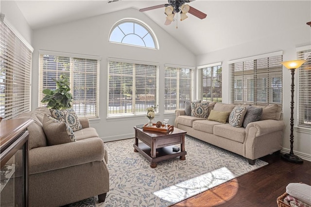 living room featuring ceiling fan, wood-type flooring, and vaulted ceiling