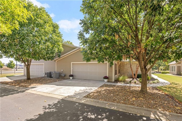 obstructed view of property with a garage and cooling unit