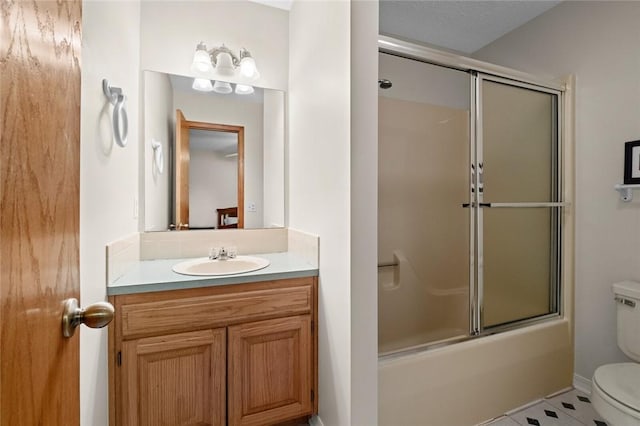 full bathroom with tile patterned flooring, vanity, toilet, and shower / bath combination with glass door