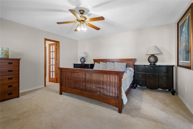 bedroom with light carpet, a textured ceiling, and ceiling fan