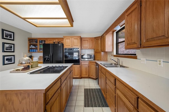 kitchen with light tile patterned floors, sink, and black appliances