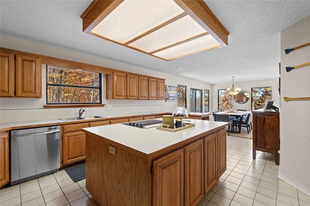 kitchen with stainless steel dishwasher, sink, decorative light fixtures, an inviting chandelier, and a kitchen island