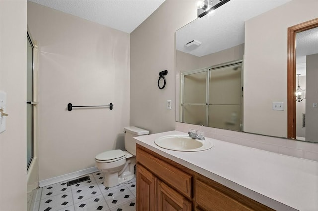 full bathroom featuring vanity, toilet, a textured ceiling, and combined bath / shower with glass door