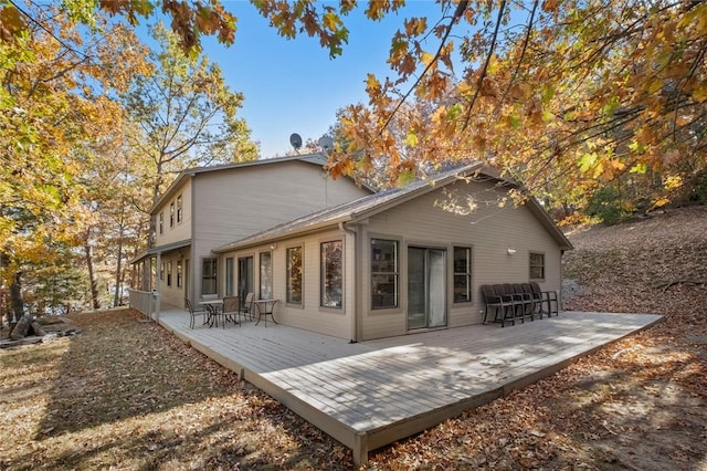 rear view of house featuring a wooden deck