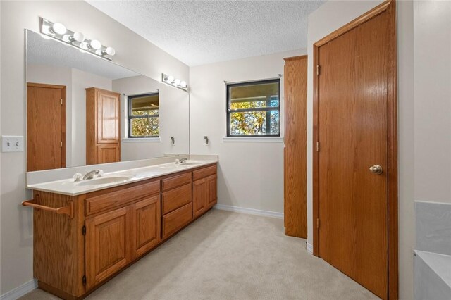 bathroom featuring a textured ceiling and vanity