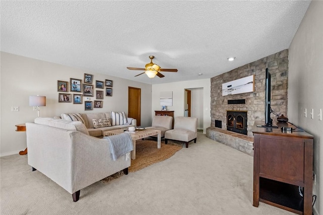 carpeted living room featuring ceiling fan and a textured ceiling