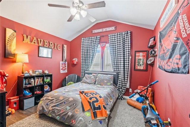 bedroom featuring hardwood / wood-style floors, ceiling fan, and lofted ceiling