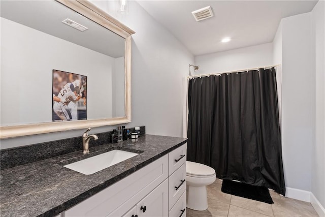 bathroom with tile patterned floors, vanity, and toilet