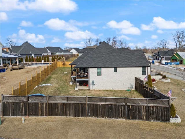 rear view of property featuring a yard