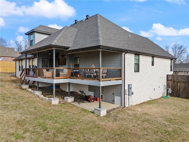 back of house with a lawn, a patio area, and a deck