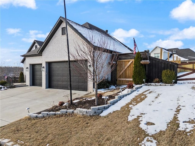 snow covered property with a garage