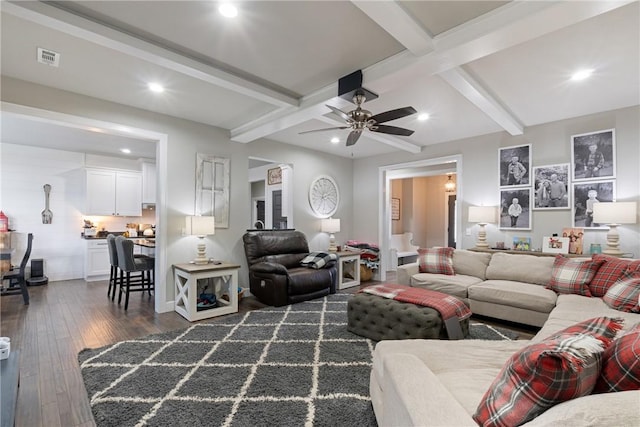 living room featuring beam ceiling, ceiling fan, and dark hardwood / wood-style floors