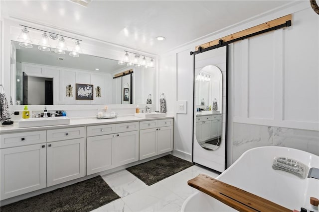 bathroom with crown molding, vanity, and a bath