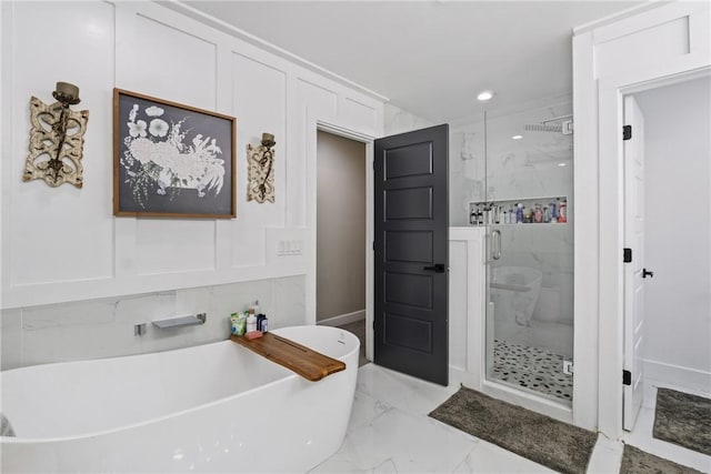 bathroom featuring shower with separate bathtub