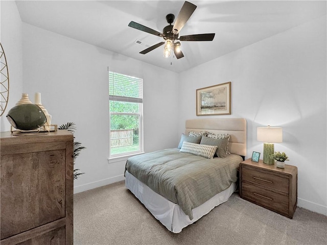 bedroom with light carpet, visible vents, ceiling fan, and baseboards