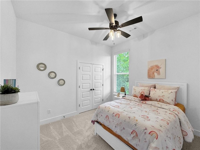 carpeted bedroom with baseboards, visible vents, a closet, and ceiling fan