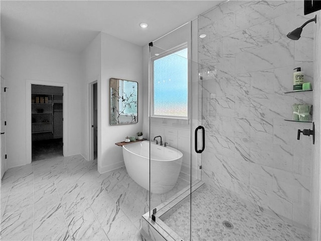 full bath featuring recessed lighting, a marble finish shower, a freestanding bath, and marble finish floor