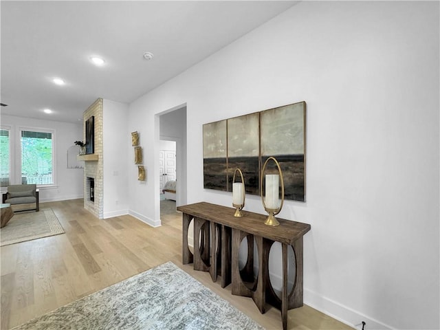 hall featuring recessed lighting, light wood-type flooring, and baseboards