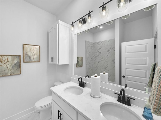 bathroom with a sink, baseboards, toilet, and marble finish floor