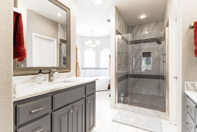 bathroom featuring separate shower and tub, tile patterned flooring, vanity, and a notable chandelier