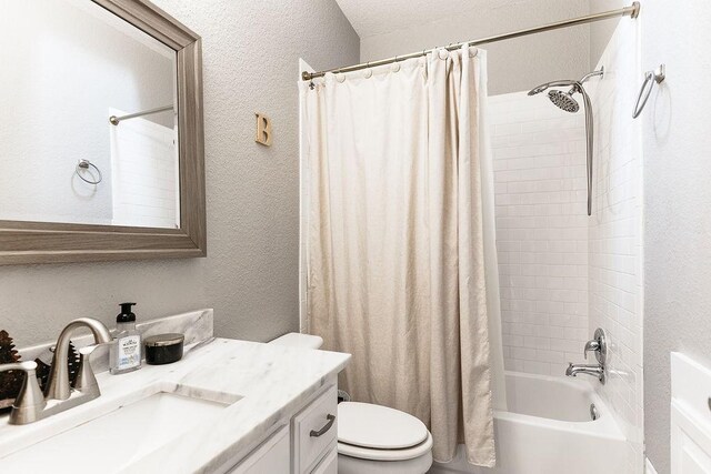 full bathroom featuring vanity, toilet, a textured ceiling, and shower / tub combo with curtain