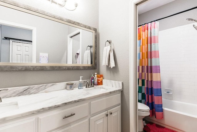 full bathroom featuring shower / bath combo, vanity, and toilet