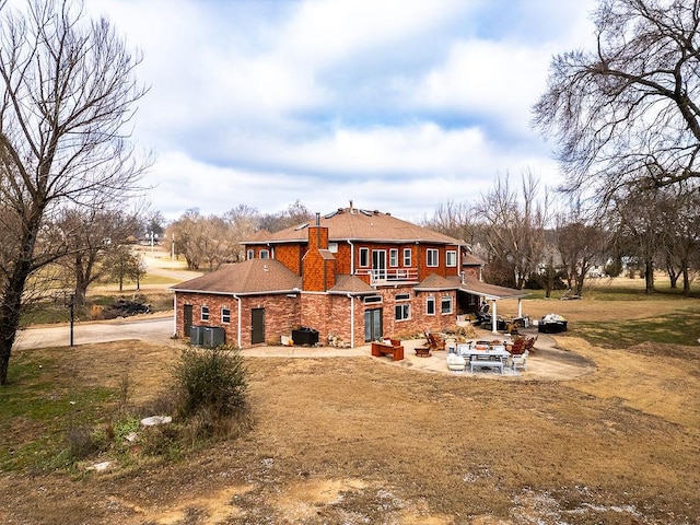 back of property featuring a patio and central air condition unit