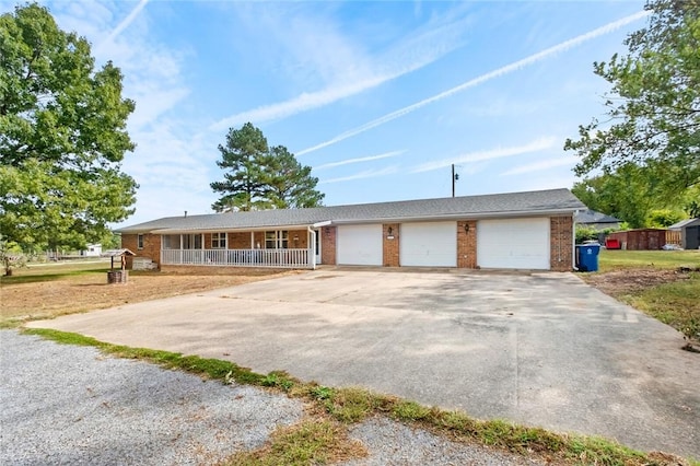 single story home with a porch and a garage