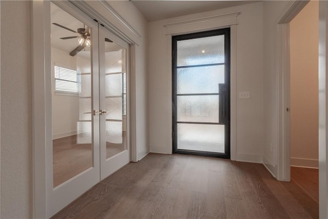 doorway with french doors, ceiling fan, and hardwood / wood-style floors